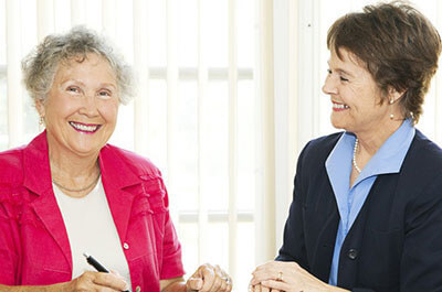 Elderly Woman Signing Paperwork - In Home Aged Care - ESP Healthcare