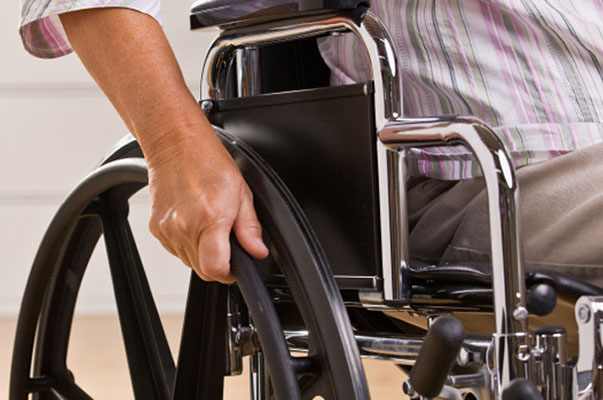 Hand Pushing The Wheelchairs Wheel - Sydney Home Care - ESP Healthcare