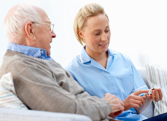 A Female Nurse Explaining To a Senior Man About His Medication - Home Care Sydney - ESP Healthcare