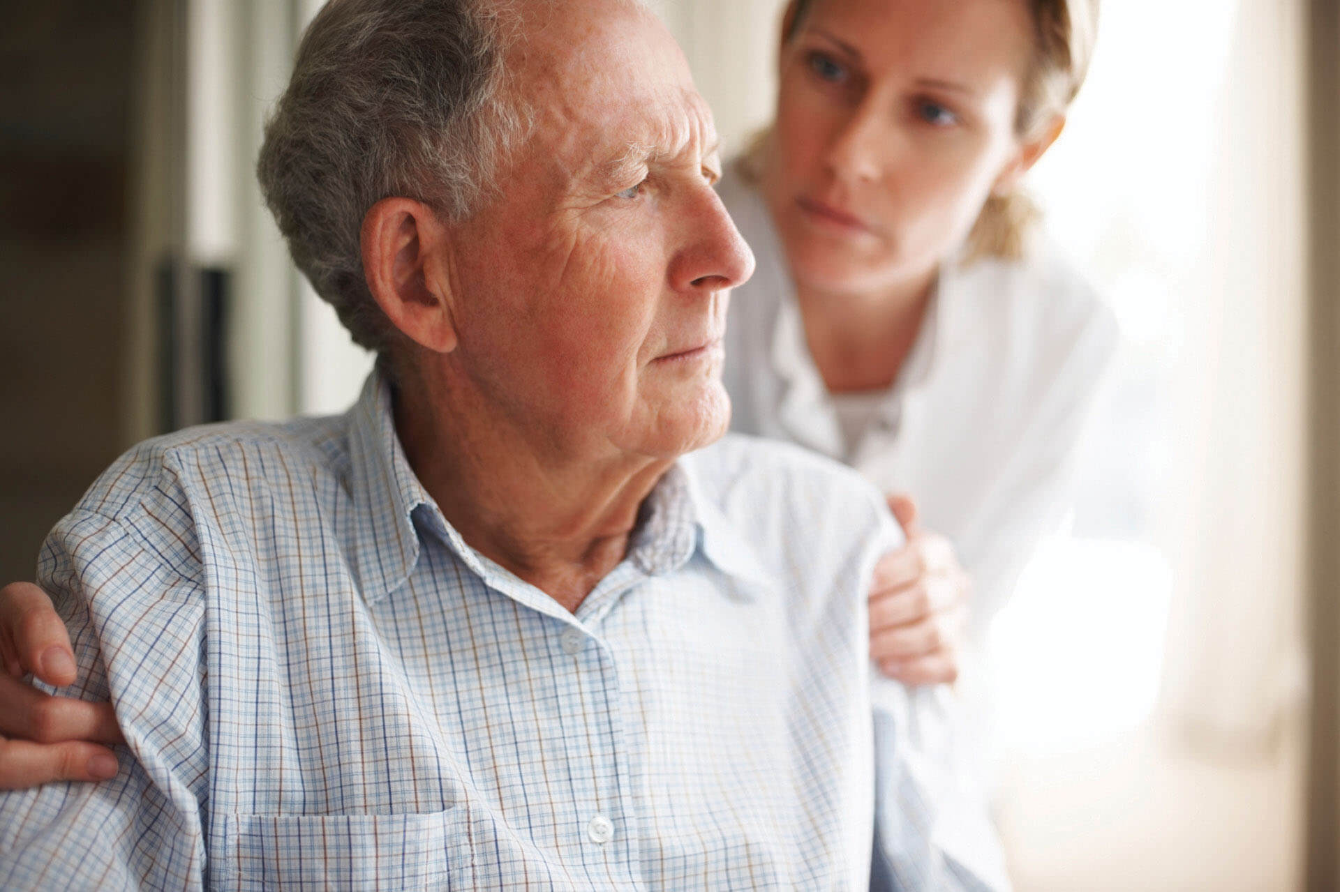 A Female Nurse Comforting An Old Worried Man - Home Care For Elderly - ESP Healthcare