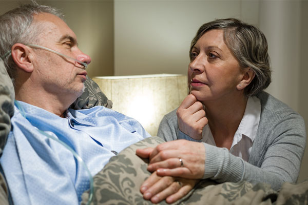 Woman Holding The Hands Of Her Sick Husband - Home Care Package Provider - ESP Healthcare