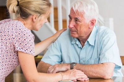 A Nurse Talking To An Elderly Man While Holding His Hand - Home Care Solutions - ESP Healthcare