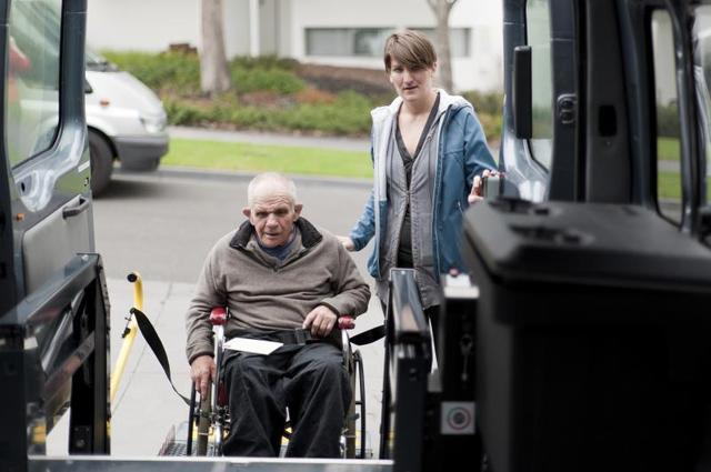 A Man Helps An Old Man In A Wheelchair In The Car - In Home Help For The Elderly - ESP Healthcare